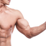 Muscular bodybuilder with a shaker full of whey protein on white background
